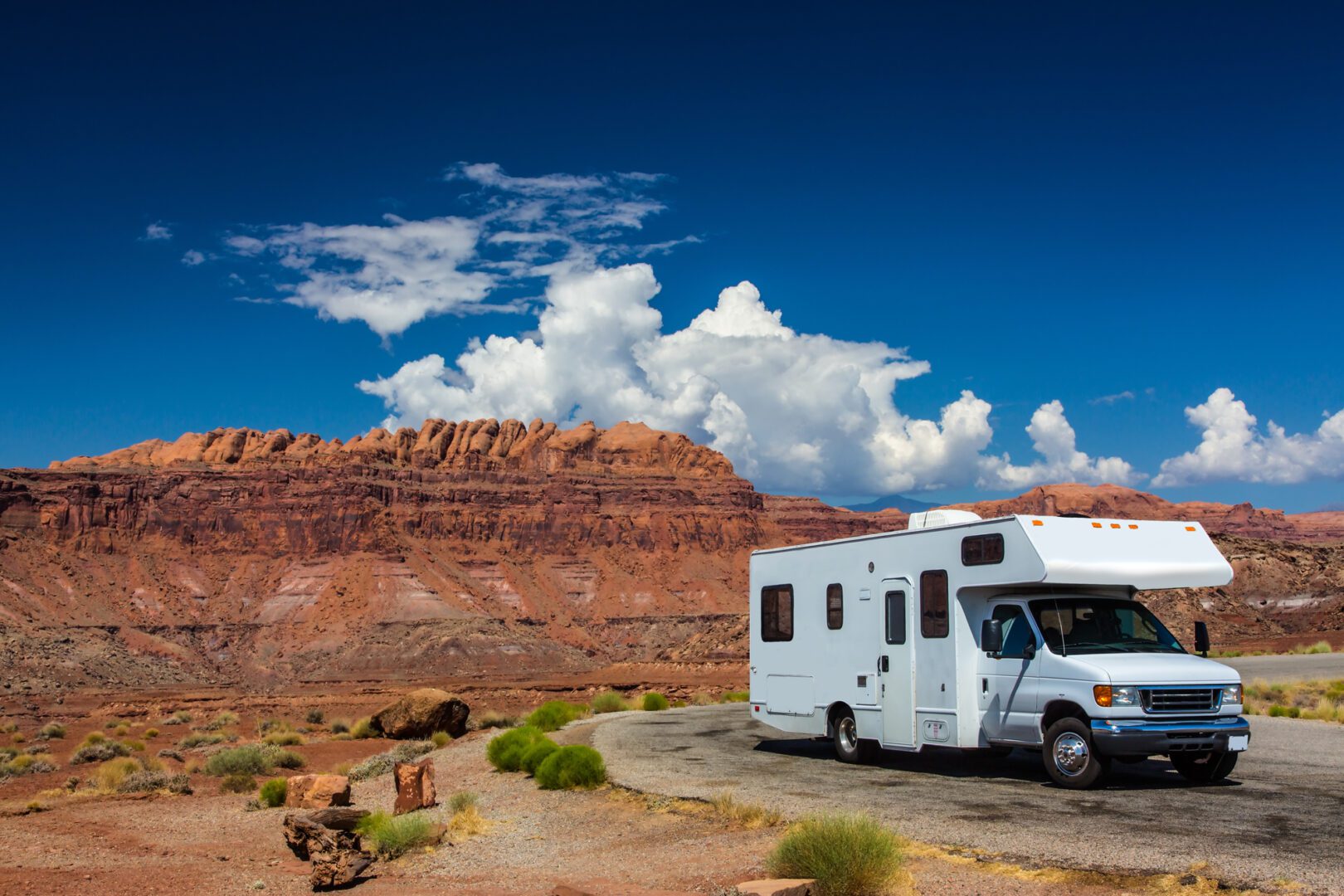 A white rv parked on the side of a road.
